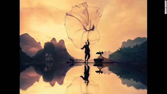 <strong>Fisherman: </strong>Khalid Alsabat of Saudi Arabia photographed this scene at sunrise when he was staying in Yangzhou, China. "The elderly Chinese fisherman in his traditional clothes pushed his bamboo boat into the water, carrying with him a fishing net, a light, and two cormorants," Alsabat says.<br />Copyright: © Khalid Alsabat, Saudi Arabia, 1st Place, National Awards, 2017 Sony World Photography Awards