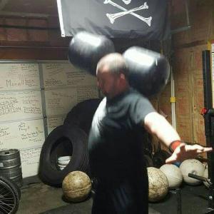 stephen dalton doing circus dumbbell at 14:23 Strength Club