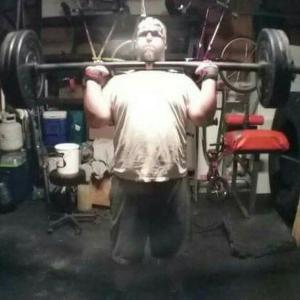 stephen dalton doing overhead press at 14:23 Strength Club