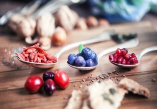 Superfood: Spoons of various superfoods on wooden background