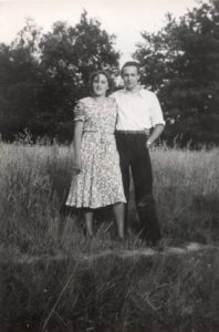 a young couple standing in a field