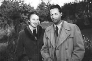 a young couple standing in a garden