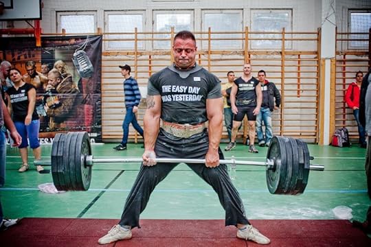 Strong man deadlifting.