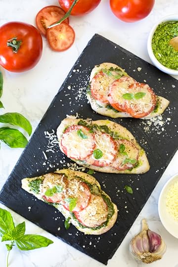 Chicken Pesto Bake is a simple, light dish made with skinless chicken breasts, pesto, tomatoes, mozzarella and Parmesan cheese. You can make this in the oven, or make it outside on the grill!