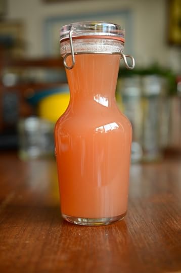 A finished bottle of honey sweetened rhubarb meyer lemon cordial.