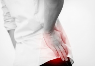 Young man in casual office shirt having hip pain