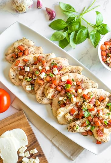 Grilled Chicken Bruschetta is a summer staple in my house! Made with juicy tomatoes, mozzarella, basil, red onion, garlic and balsamic, it turns plain grilled chicken into a delicious weeknight meal in minutes!
