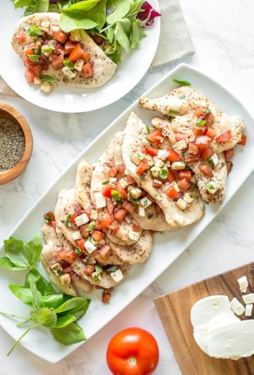 Grilled Chicken Bruschetta is a summer staple in my house! Made with juicy tomatoes, mozzarella, basil, red onion, garlic and balsamic, it turns plain grilled chicken into a delicious weeknight meal in minutes!