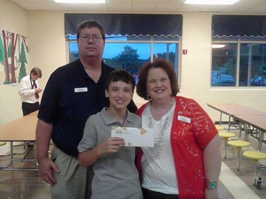 Image may contain: 3 people, people smiling, people standing