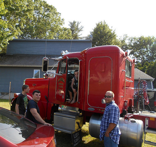 Big red truck calls the boys to the yard