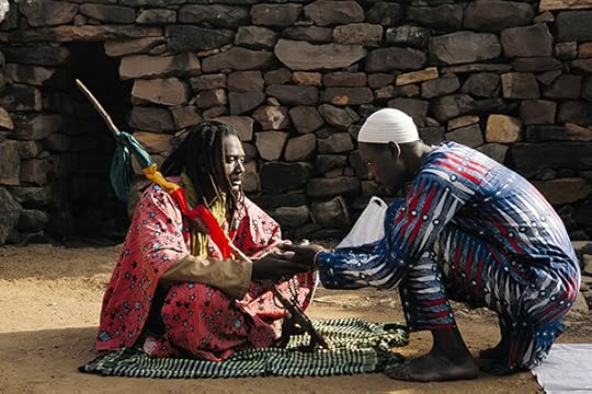 Seydou Camara, One of the sons of the late El Hadji Soufi Adama Yalcouye receives a worshiper in their mosque, which was built in the midst of the Niger’s riverbed, 2016 Courtesy the artist
