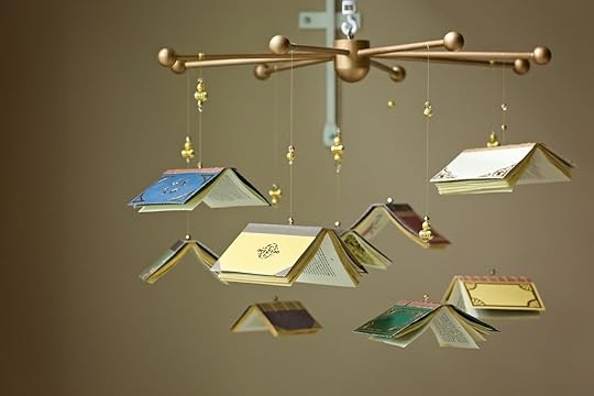 Baby mobile with small books hanging from it