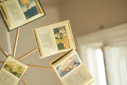 Baby mobile with small books hanging from it