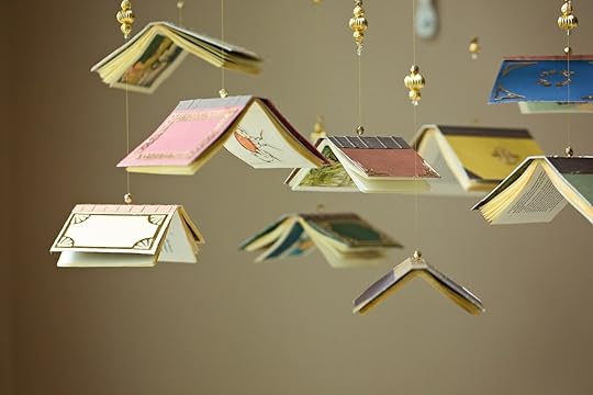 Baby mobile with small books hanging from it