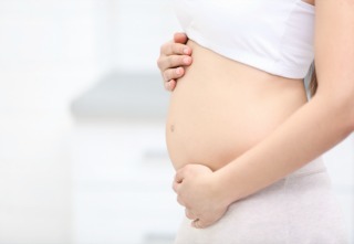 Pregnant woman on light background