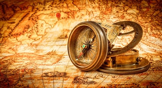 Vintage compass lies on an ancient world map.