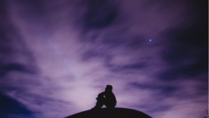 silhouetted figure on rock