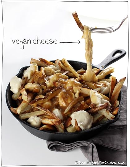 Classic Canadian comfort food: The Ultimate Vegan Poutine. Baked crispy French fries, topped with quick and easy dairy-free cheese curds, smothered in rich onion gravy. #itdoesnttastelikechicken