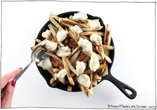 Classic Canadian comfort food: The Ultimate Vegan Poutine. Baked crispy French fries, topped with quick and easy dairy-free cheese curds, smothered in rich onion gravy. #itdoesnttastelikechicken