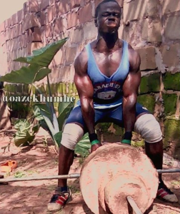 nigerian bodybuilder doing t bar rows outside