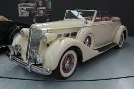 A cream yellow packard convertible.