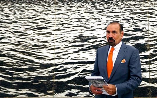 In this photo taken Thursday, June 8, 2017, Jorge Perez talks to guests and reporters at the Perez Art Museum Miami, in Miami. The piece behind Perez is called 