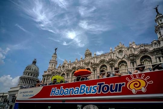 In this file photo, visitors ride a tour bus in front of the Capitolio in Havana. U.S. Treasury on Tuesday announced new clarifications on Cuba travel.