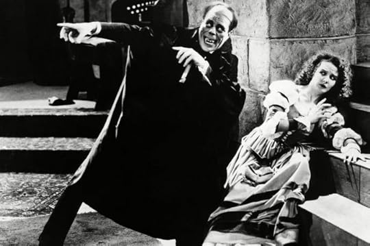 Lon Chaney and Mary Philbin in the 1925 silent movie The Phantom of the Opera— although the “grisly mask” he wore limited his facial expressiveness, “Chaney’s best acting, with his hands, is to be seen in this picture,” according to reviewer Carl Sandburg. Public Domain via Wikimedia Commons.