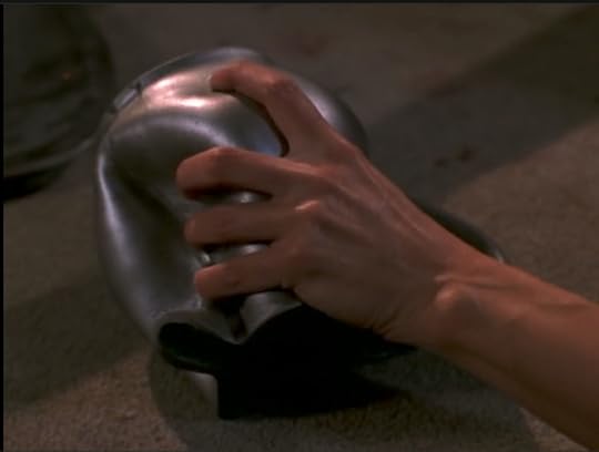 Buffy's hand, squeezing dents into a metal pitcher