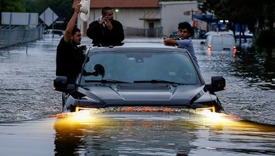 Residents use a truck to navigate through floodwaters from Harvey in Houston, Texas.