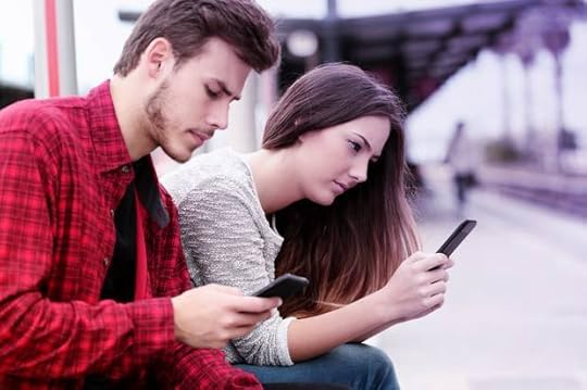 Teens obsessed with smart phones in a train station