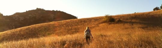 Woman hiking fall grasslands.