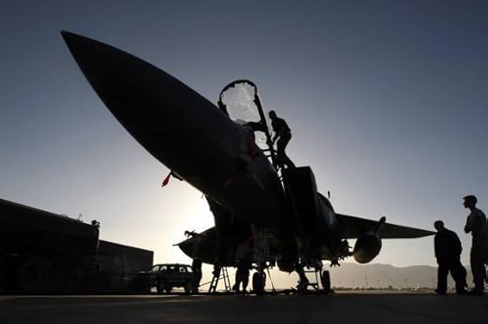 Members of the ground crew work on U.S. Air Force F-15E fighter jet following a mission over Afghanistan at Bagram air base