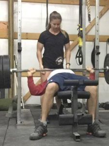 Anna Woods training a client in her Garage Gym Life t shirt