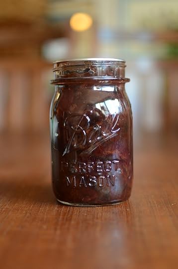 A jar of plum conserve with golden raisins and walnts