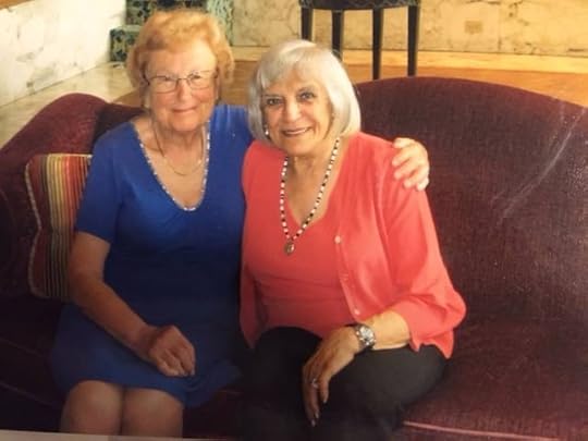 Image may contain: 2 people, people smiling, people sitting