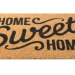 A brown spiky welcome mat bearing the words, 