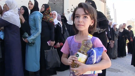 FILE PHOTO: Residents queued up for food and supplies, as the humanitarian aid from the first convoy was distributed in Deir ez-Zor, September 8, 2017 Â© Ruptly