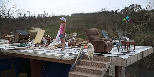 COROZAL, PUERTO RICO - SEPTEMBER 27: Irma Maldanado stands with Sussury her parrot and her dog in what is left of her home that was destroyed when Hurricane Maria passed through on September 27, 2017 in Corozal, Puerto Rico. Puerto Rico experienced widespread damage including most of the electrical, gas and water grid as well as agriculture after Hurricane Maria, a category 4 hurricane, passed through. (Photo by Joe Raedle/Getty Images)