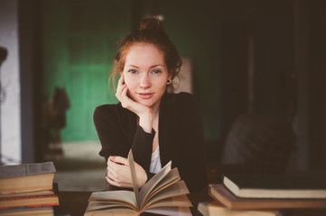 red haired woman with books