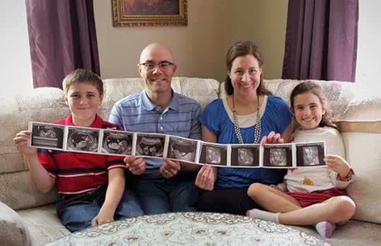 The Lundy Family holding ultrasound pictures of Baby Stafford!