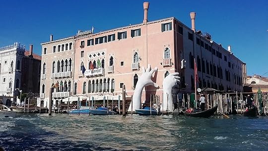 Hands arising out of the water to save the building