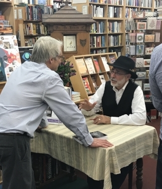 Rabbi Arthur Gross Schaefer signs a book for a fan.