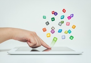 application icons fly off the tablet computer in hand