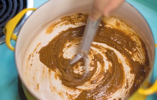 Stirring toasted flour and turkey drippings into roux