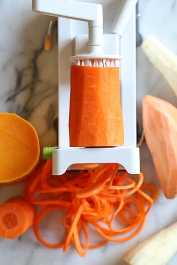 Spiralized Winter Veggie Gratin is the perfect holiday side dish! Made with spiralized vegetable gratin is made with sweet potatoes, butternut squash, carrots, and parsnips and topped with a white sauce and Gruyere cheese.