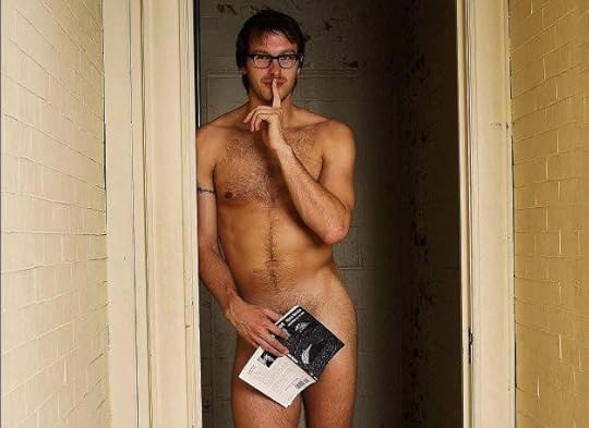 photo of a naked man in a doorway with a book