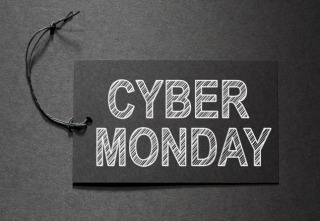 Cyber Monday text on a black tag on black paper background