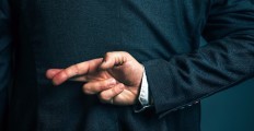 lying-businessman-holding-fingers-crossed-behind-his-back-picture-id533045396