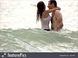 couple playing in the ocean